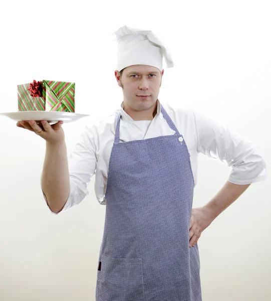 Chief cook with a gift on a plate — Stock Photo, Image