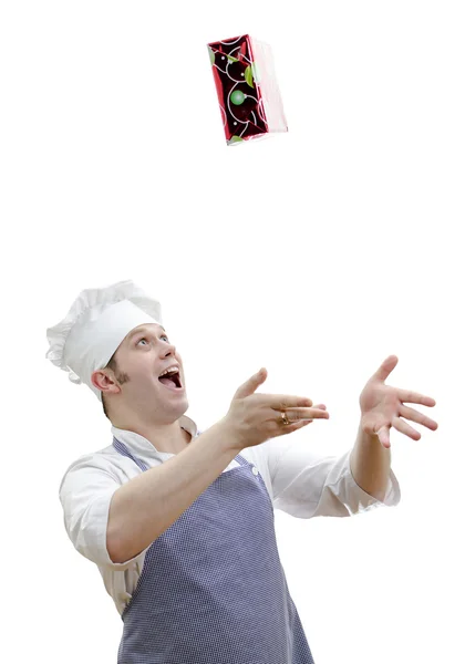 Επικεφαλής μάγειρας πετώντας ένα δώρο, που απομονώνονται σε λευκό — Φωτογραφία Αρχείου