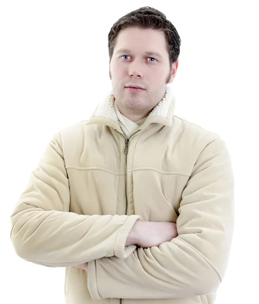 Portret przystojny, młody człowiek w płaszcz zimowy z ramionami skrzyżowanymi. na białym tle — Zdjęcie stockowe