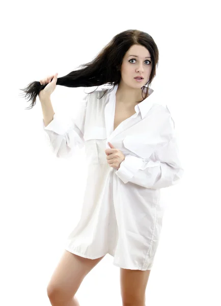 Sensual brunette girl in man's shirt touching her hair. Isolated on wh — Stock Photo, Image
