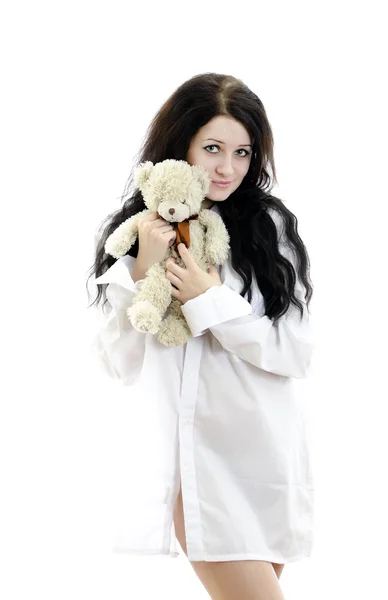 Sensuele brunette meisje in iemands shirt met Teddy Bear. Geïsoleerd op whit — Stockfoto