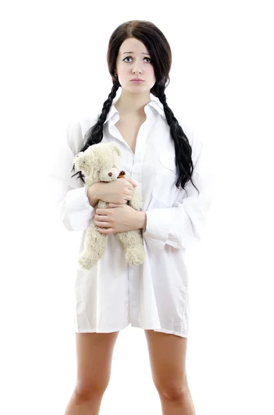 Sensuele brunette meisje in iemands shirt met Teddy Bear. Geïsoleerd op whit — Stockfoto