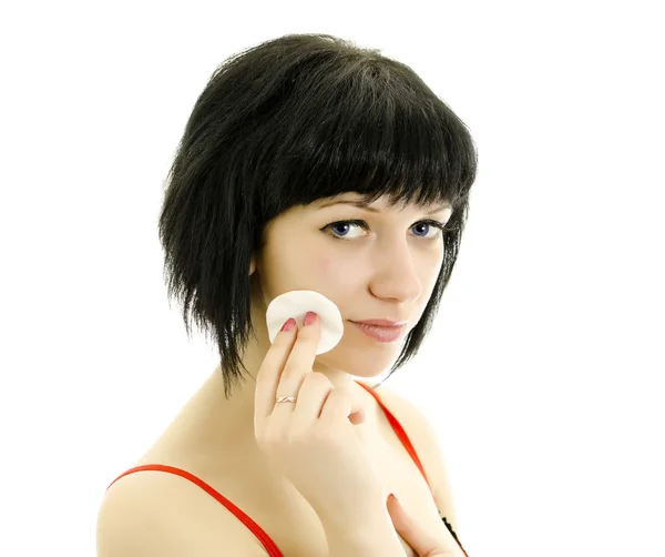 Close-up portrait of woman with cotton swab cleaning her face. Isolated on — Stock Photo, Image