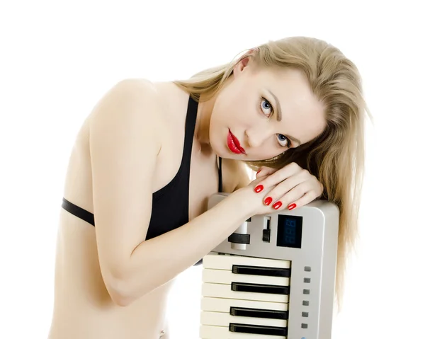 Woman in black swimsuit posing with Piano keyboard. Isolated on white. — Stock Photo, Image