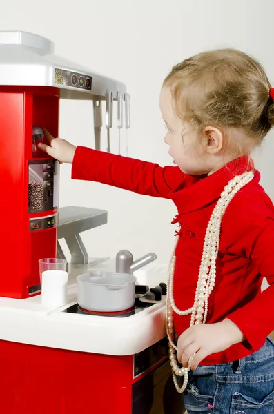 Little cute girl playing in children's kitchen. — Stock Photo, Image
