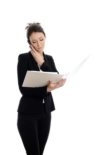 Attractive woman with mobile phone reading documents. Isolated on white. — Stock Photo, Image