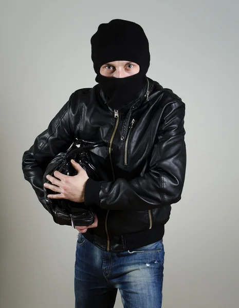 Portrait of male burglar with a handbag. — Stock Photo, Image