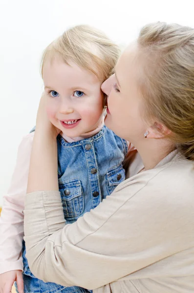 Attractive female and her daughter sharing secrets. — Stock Photo, Image