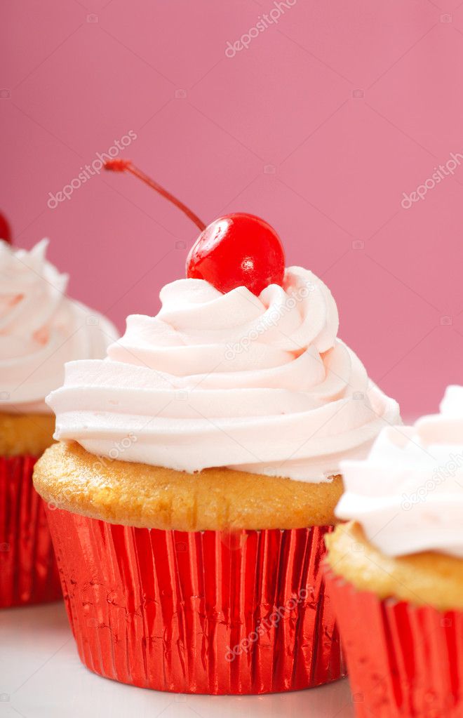 Vanilla cupcake with maraschino frosting and cherry