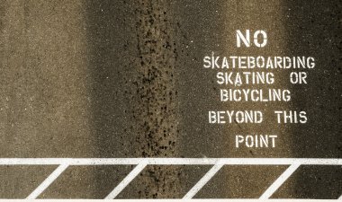 No skateboarding sign painted on footpath clipart