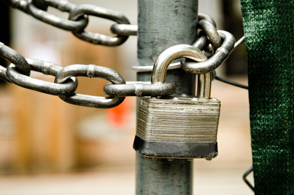 A lock and chain on metal gate