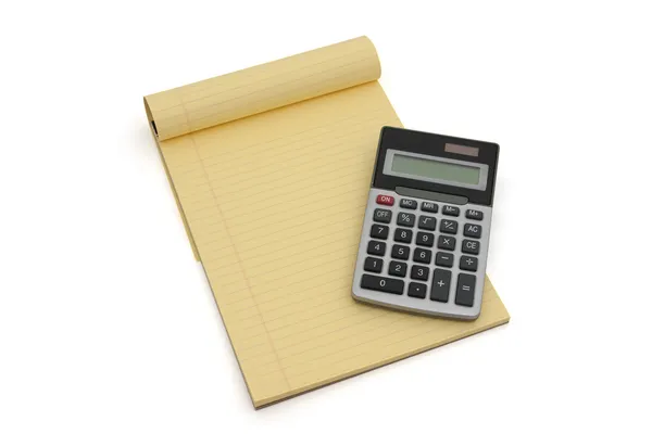 Калькулятор и блокнот с жёлтой подкладкой — стоковое фото