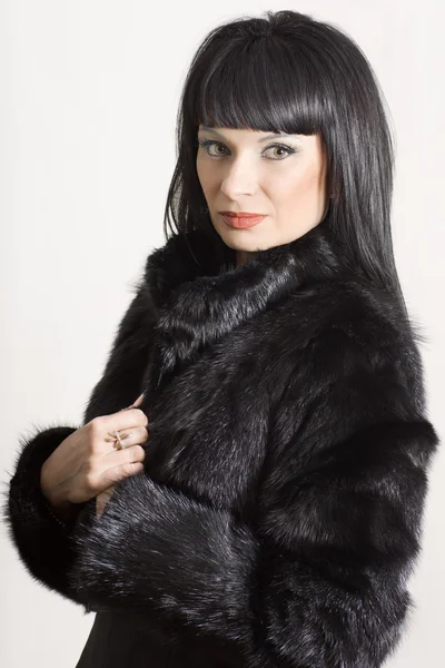 Portrait of a beautiful elegant woman in a black coat — Stock Photo, Image