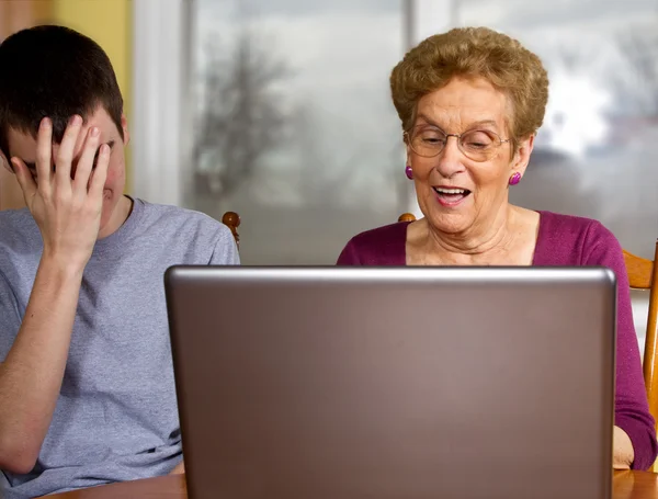 Grandson and grandmother at a laptop — Stock Photo, Image