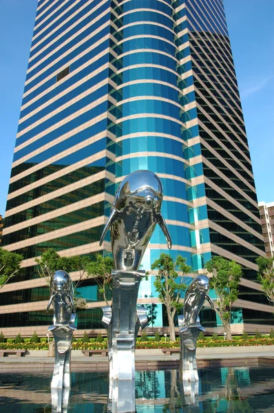 Dolphin statue and business building — Stock Photo, Image