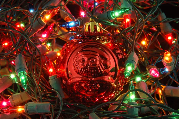 Red christmas ball in christmas lights — Stock Photo, Image