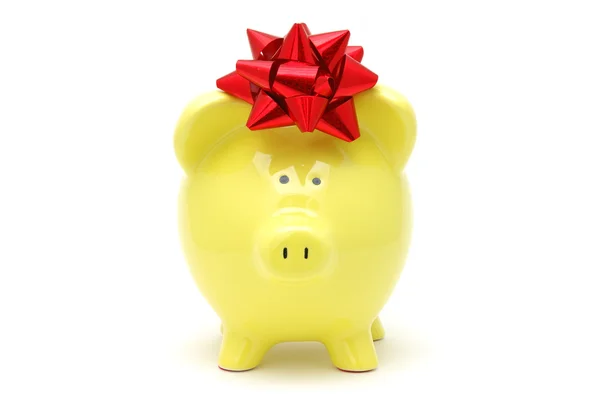 Yellow piggy bank with bow — Stockfoto