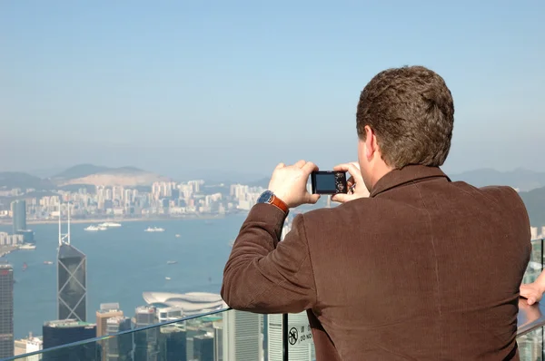 stock image Tourist taking photo of Hong Kong skyline