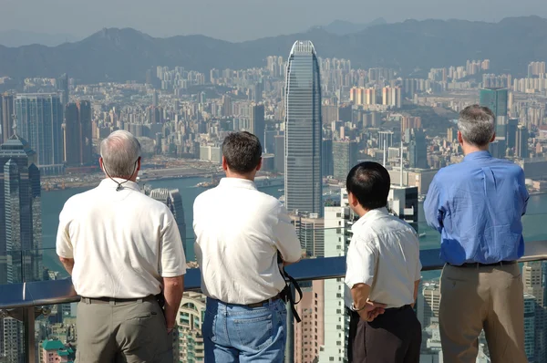 stock image Four gentlemen looking at the commerical city