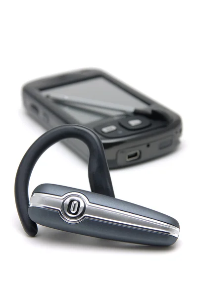 Bluetooth headset a pda telefon — Stock fotografie