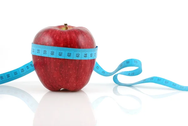 Red apple with measuring tape — Stock Photo, Image