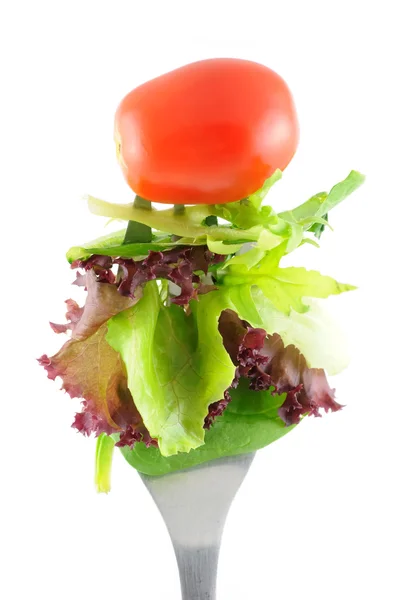 Lettuce and tomato on fork — Stock Photo, Image
