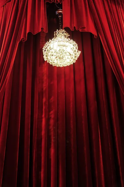 Chandelier with red curtains — Stock Photo, Image