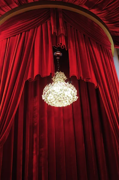Chandelier with red curtains — Stock Photo, Image