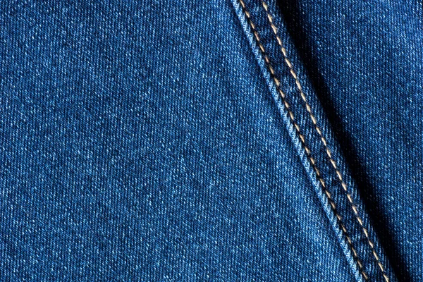 Джинсовая текстура из синих джинсов с швом — стоковое фото