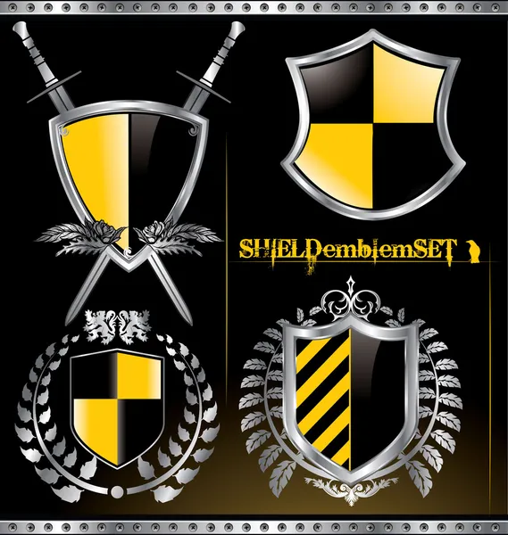 Glansigt svart och gult shield emblem set — Stock vektor