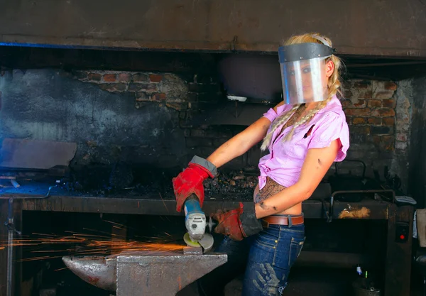 stock image Attractive girl in workshop with instrument in hand