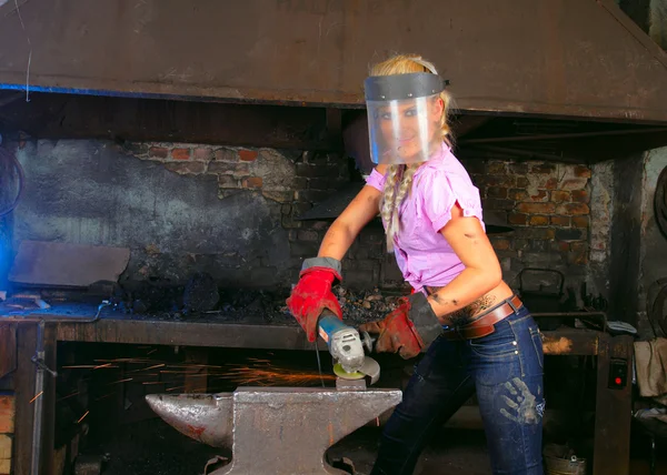 stock image Attractive girl in workshop with instrument in hand