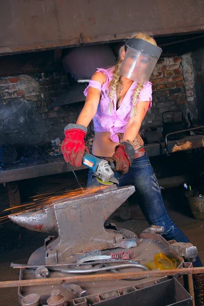 Stock image Attractive girl in workshop with instrument in hand