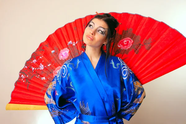 Girl in blue asian bathrobe with dragons — Stock Photo, Image