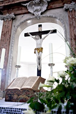 Holy Bible and Flowers on altar in the church clipart