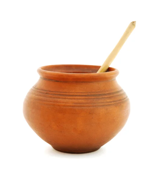 Clay pot with wooden spoon — Stock Photo, Image