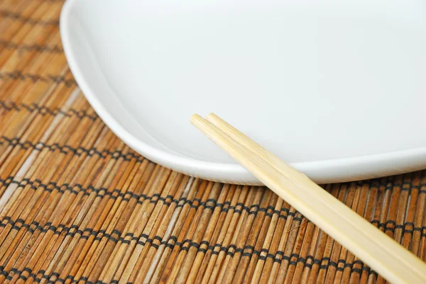 stock image Close-up of empty white plate and chopsticks
