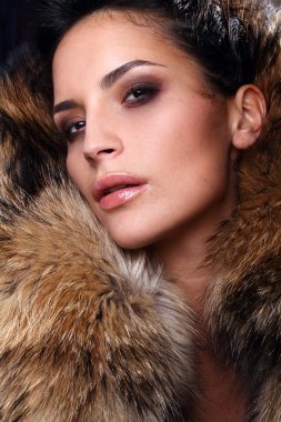 Portrait of a young fashion model wearing fox fur smoky eyes clipart