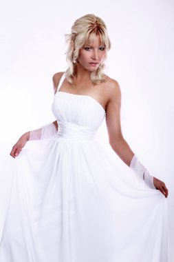 Beauty young blonde bride dressed in elegance white wedding dress clipart