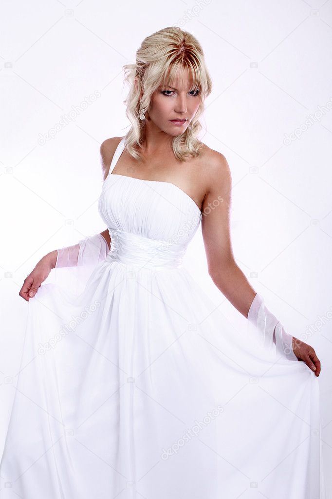 Beauty young blonde bride dressed in elegance white wedding dress