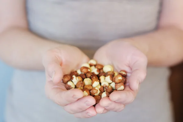 Hazelnuts in woman hands — Stock Photo, Image