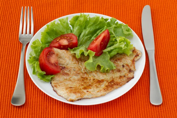 Fried turkey with salad on the white plate — Stock Photo, Image