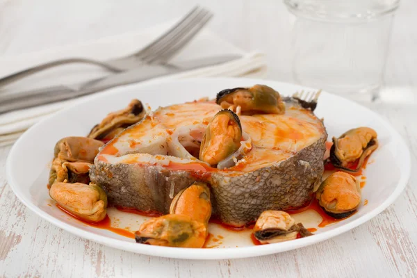 Boiled fish with sauce and mussels on the white plate — Stock Photo, Image