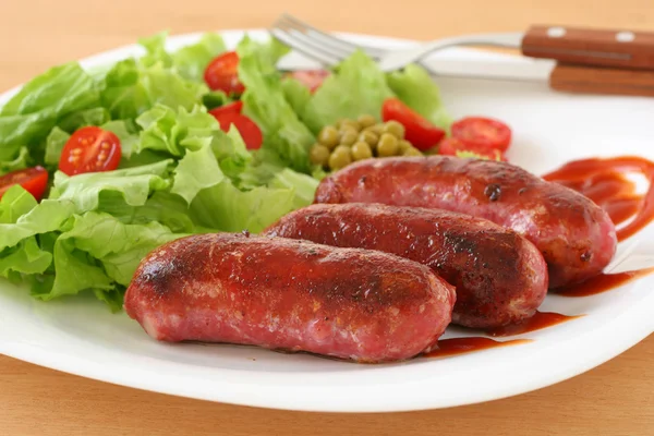 Fried sausages with salad — Stock Photo, Image