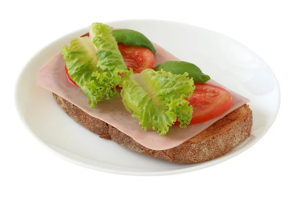 Хлеб с ветчиной, салатом и помидорами — стоковое фото