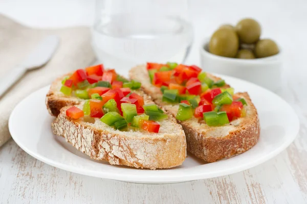 Toasts with cut pepper on the plate — Stock Photo, Image