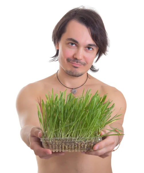 Człowiek posiadający trawa doniczka na białym tle — Zdjęcie stockowe