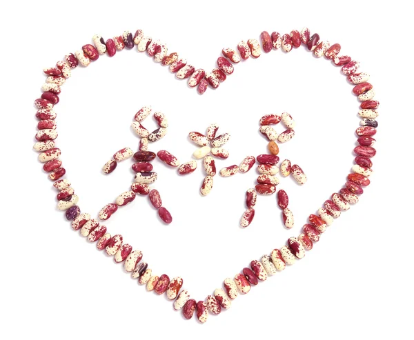 Girl and boy with flower in heart from haricot beans — Stock Photo, Image