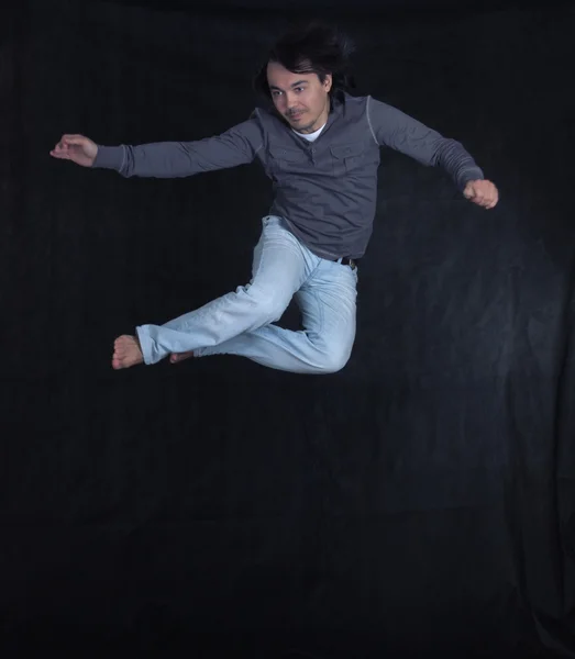 Portrait of the young beautiful man in a jump — Stock Photo, Image