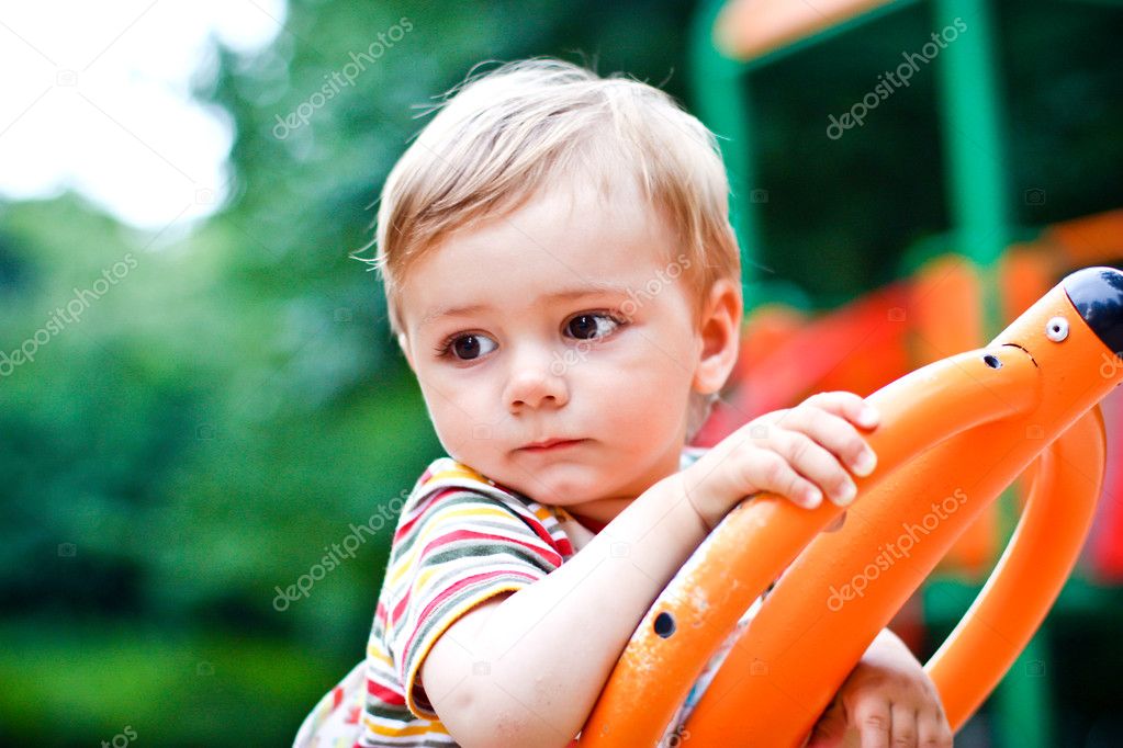 Young boy or kid playing at playground